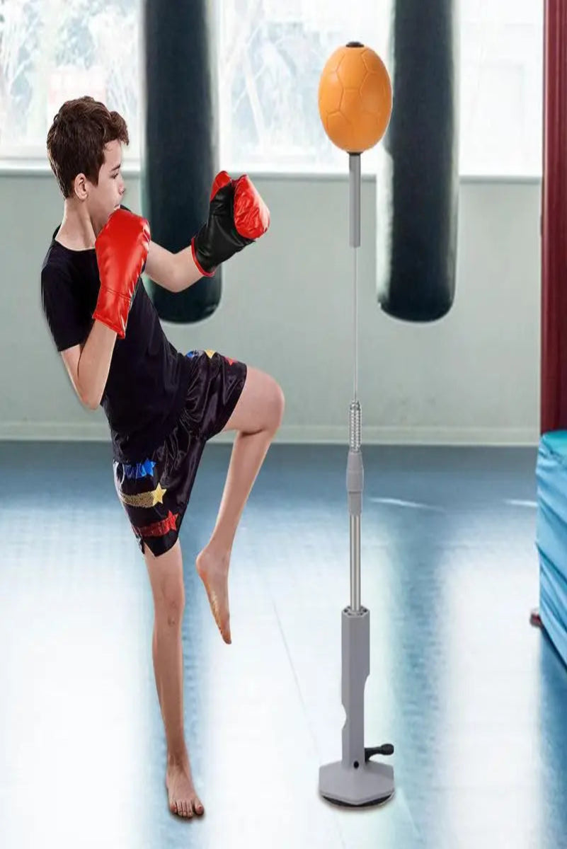 Person practicing martial arts with a punching bag and ball in a gym setting